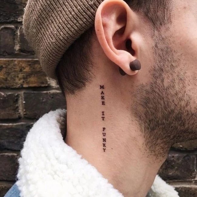 Text behind the ear tattoo