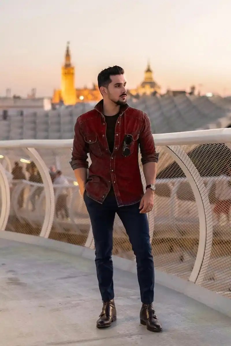 Premium Photo  A man wearing blue pants and a black t  shirt with the  word  on it 