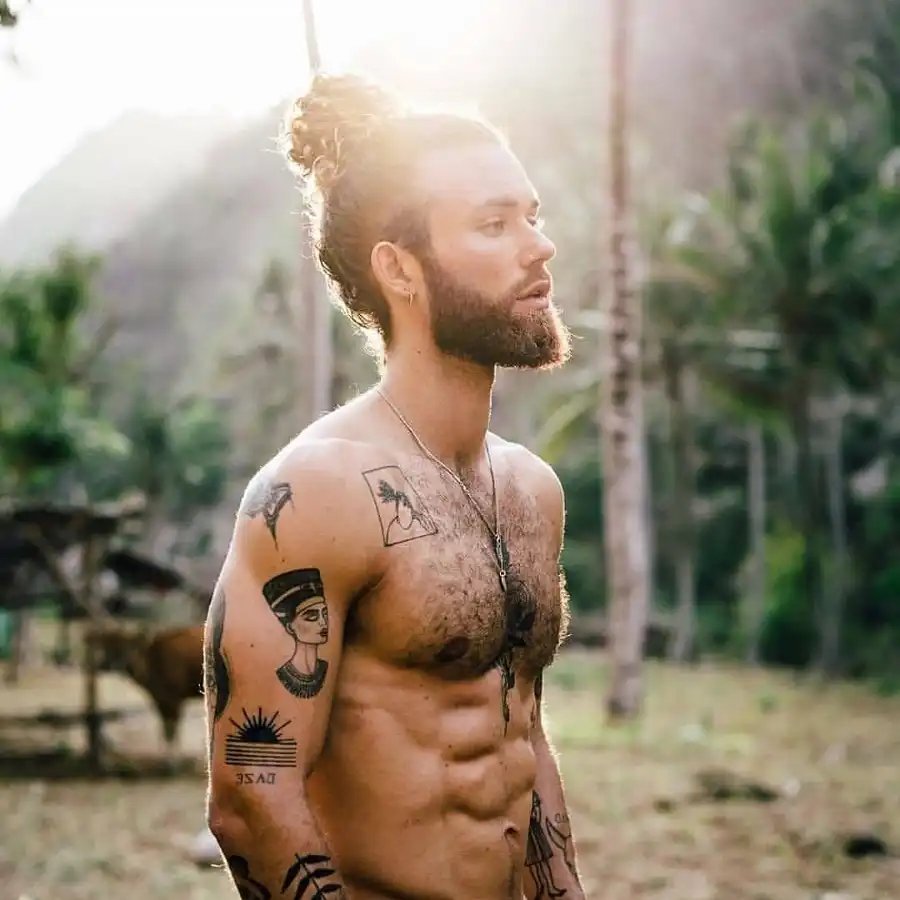 Man bun hairstyle with medium beard look men