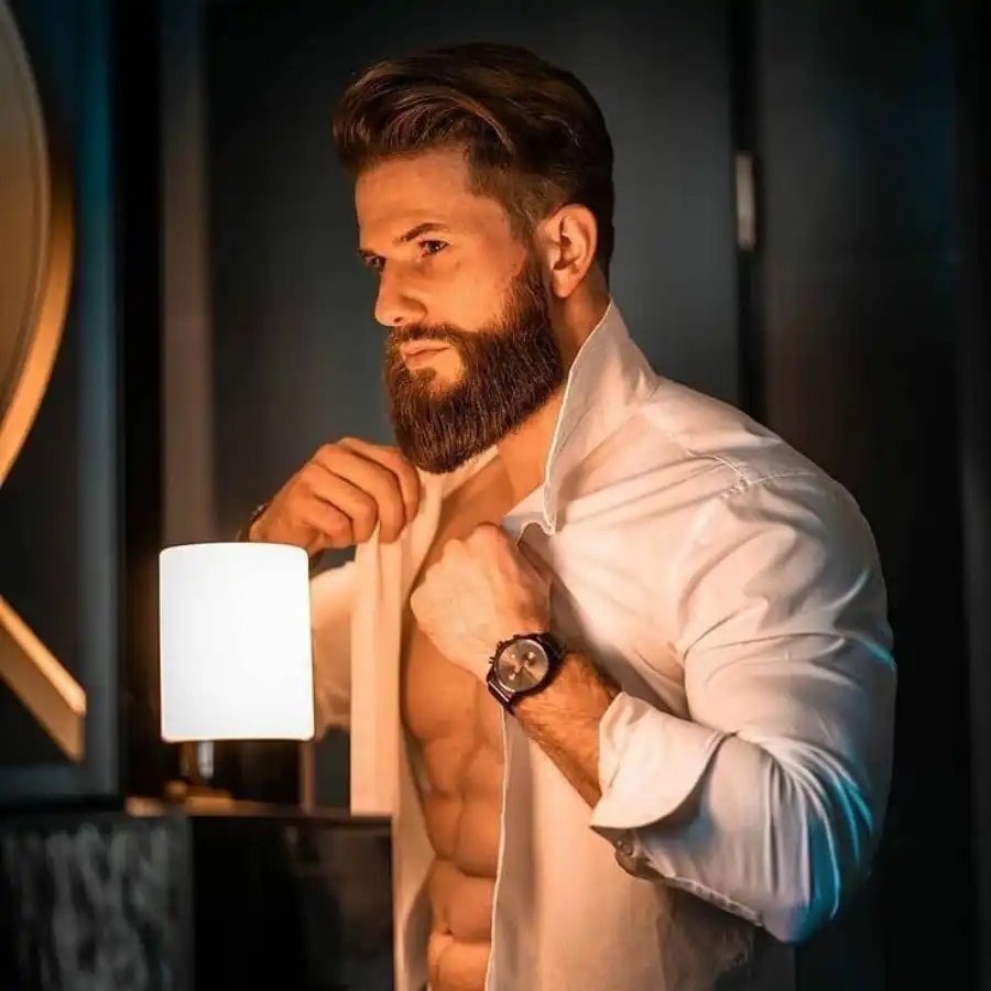 A man in medium beard open shirt