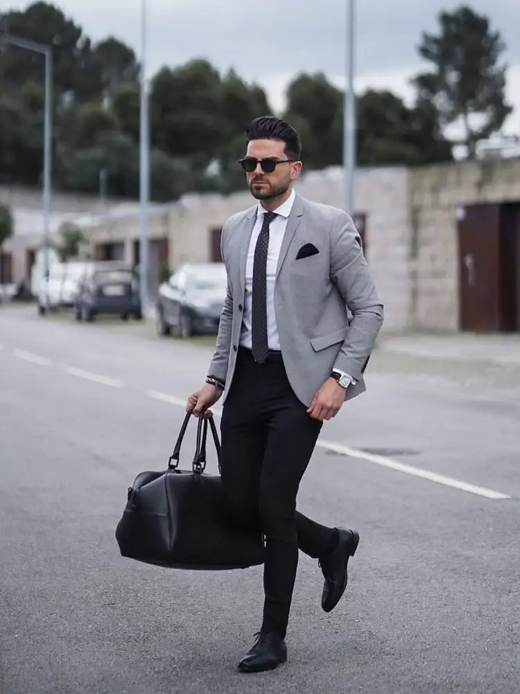 Grey blazer with black tie 