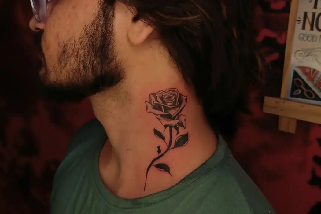 Side flower tattoo on neck