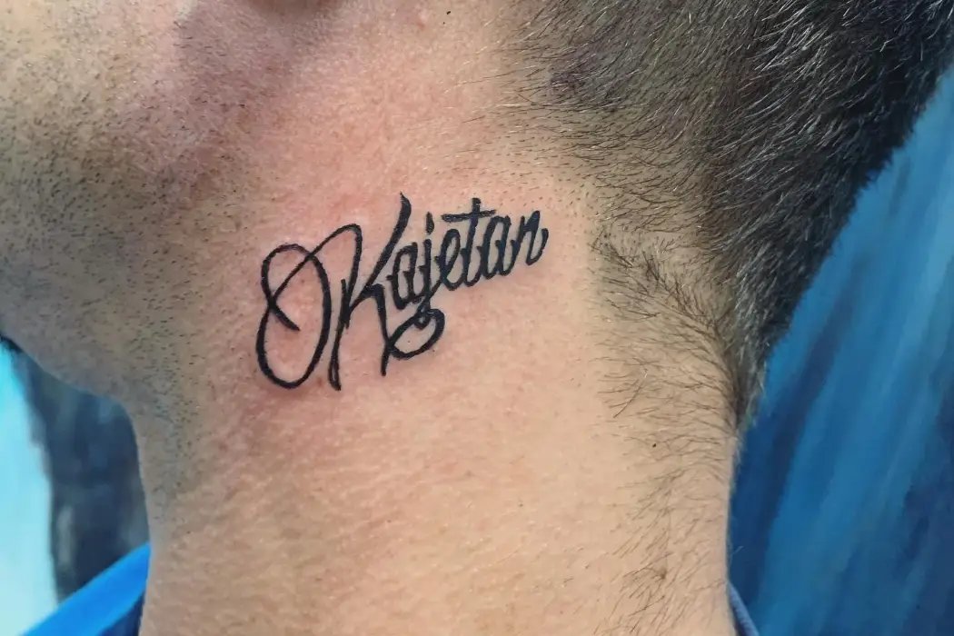 Side text font tattoo on neck