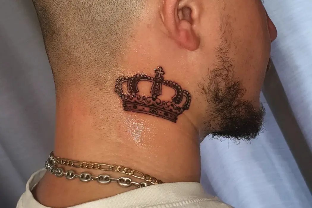 Small crown design tattoo on neck