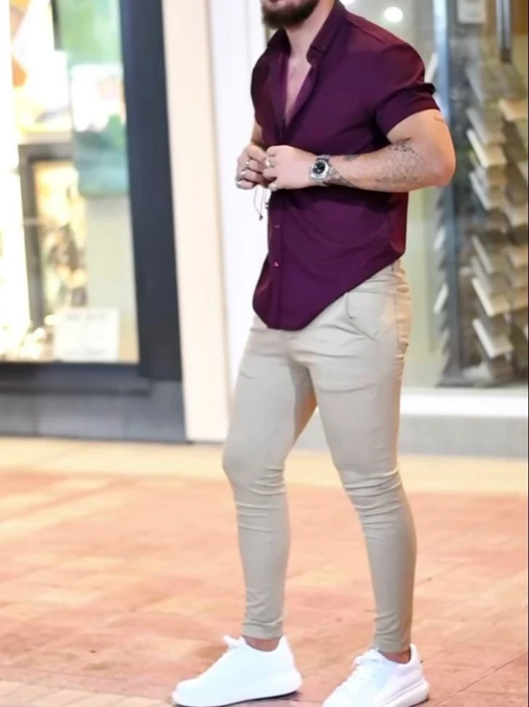 Premium AI Image  A man in a white t  shirt and purple pants stands on  the street