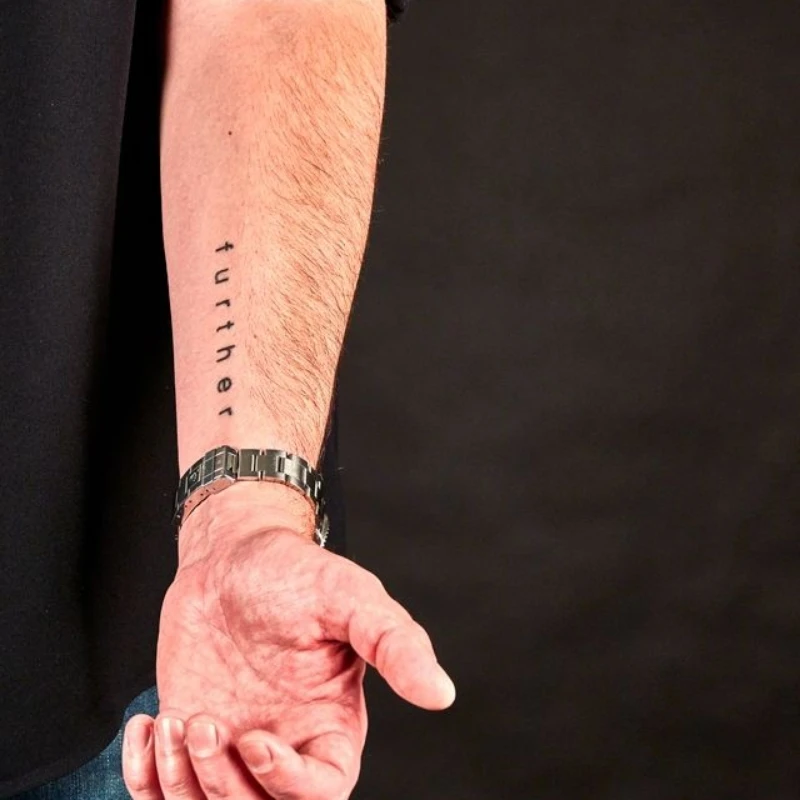 Small text tattoo on hand - further
