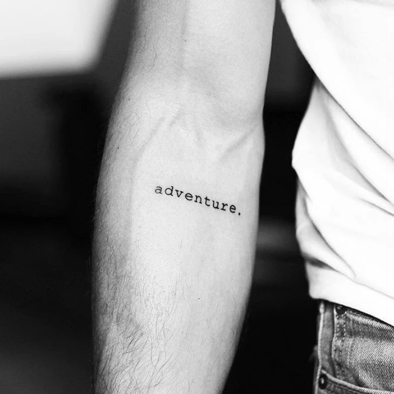 Text tattoo on hand (travel) - adventure 