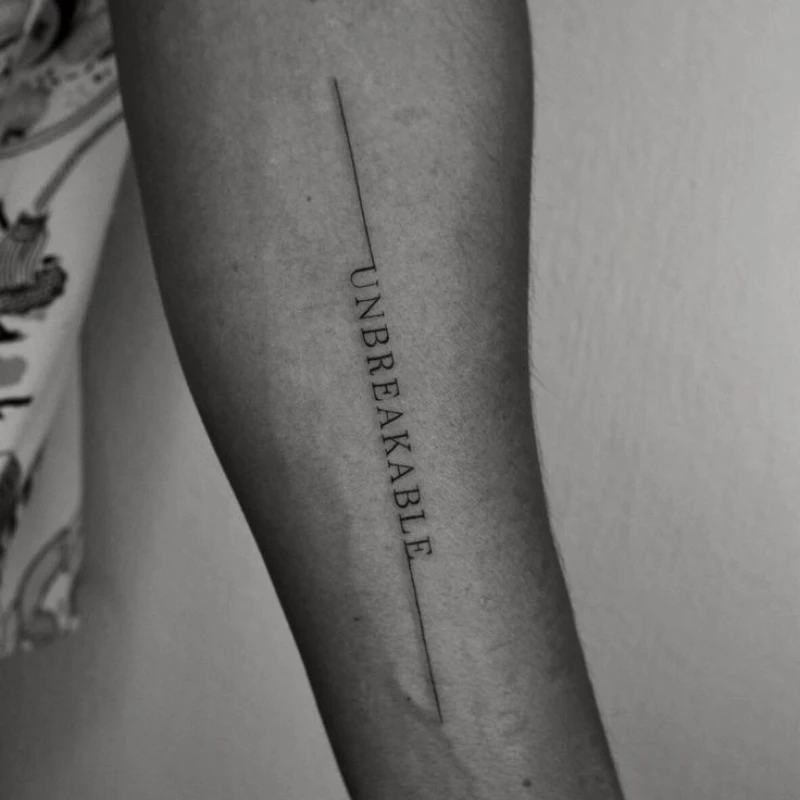 Small Text tattoo on hand - unbreakable 