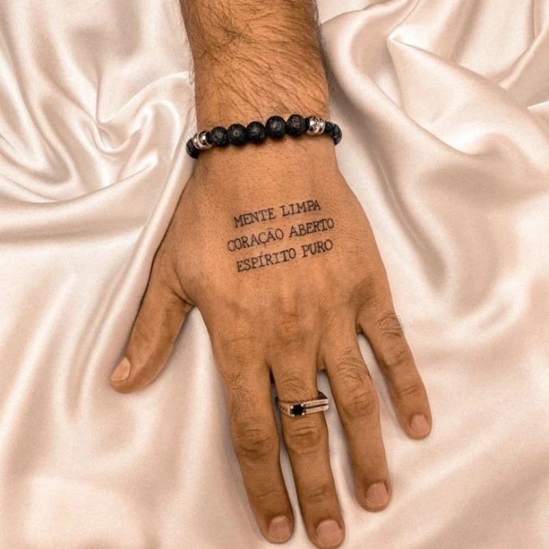 Text tattoo on hand for men 