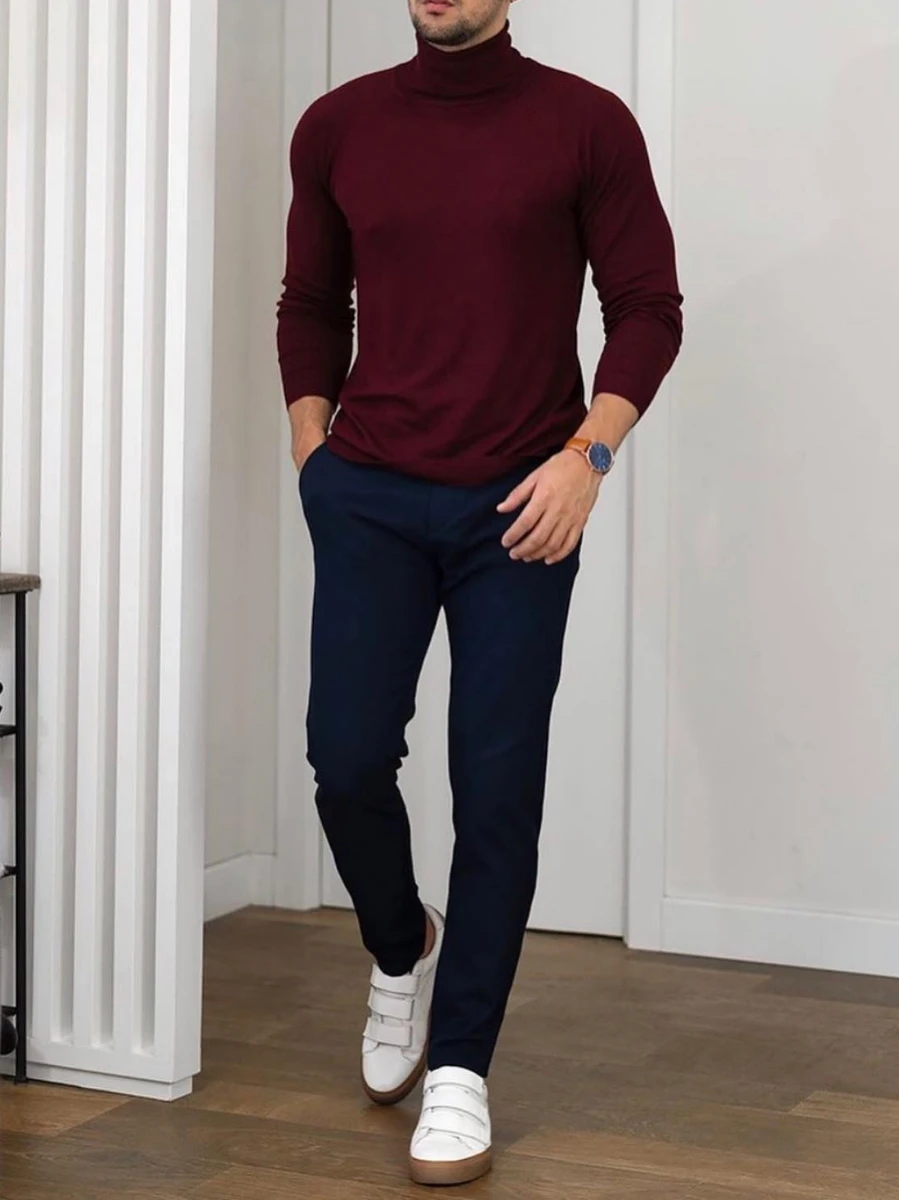 A man wearing maroon Turtleneck with Navy Blue chinos